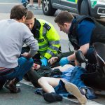 LONDON, UK - JUNE 7, 2015: The paramedics and firemen provide first aid to victims in a motorcycle accident on Piccadilly Street